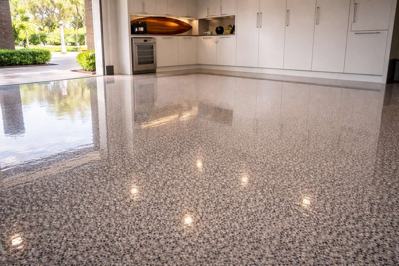 UV-stable aliphatic polyaspartic topcoat on a Newport Beach garage floor, providing high-gloss protection against coastal sun.